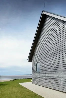a building with a window on the side of it at Airds Bay Luxury Beach House in Gatehouse of Fleet