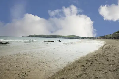 a sandy beach with footprints in the sand at The Penta in Douglas
