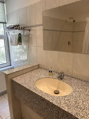a bathroom counter with a sink and a mirror at The Penta in Douglas