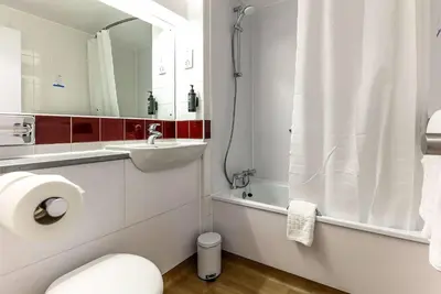 a bathroom with a toilet and a sink and a mirror at Days Inn Hotel Gretna Green in Gretna Green