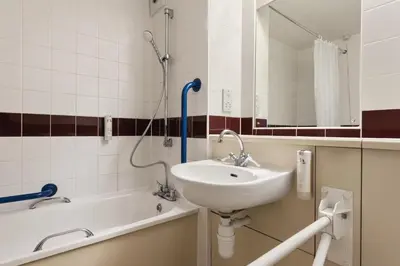 a bathroom with a sink and a shower and a tub at Days Inn Hotel Gretna Green in Gretna Green