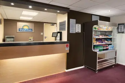 a drink dispenser in a doctors office with a refrigerator at Days Inn Hotel Gretna Green in Gretna Green