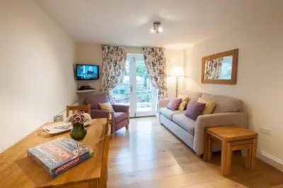 a living room with a couch and a table at Milntown Self Catering Apartments in Ramsey