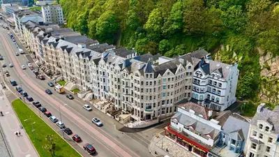 an aerial view of a city with cars on a street at The Hydro Hotel in Douglas