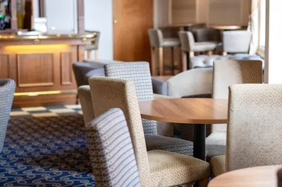 a dining room with chairs and a table and a table at The Hydro Hotel in Douglas