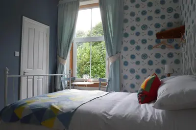 a bedroom with a bed and a window at Briar Brae Bed & Breakfast in Stranraer