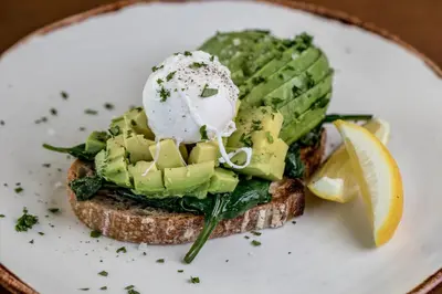 a white plate with a sandwich with an egg on it at Claremont Hotel in Douglas