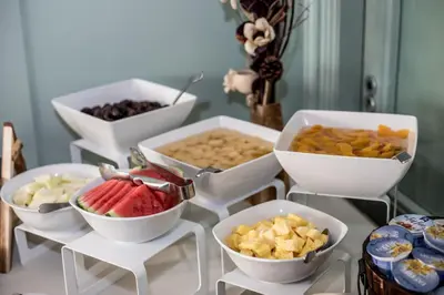a table topped with bowls of different types of food at Claremont Hotel in Douglas