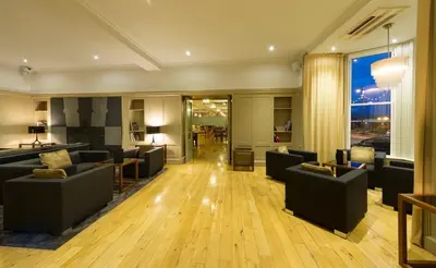 a living room with couches and a large window at Claremont Hotel in Douglas
