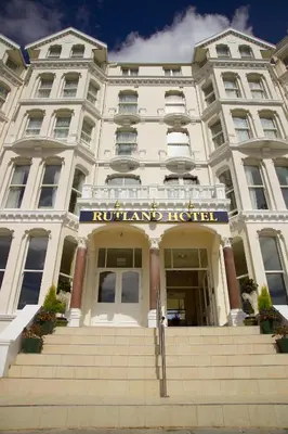 a hotel building with a sign on the front of it at The Rutland Hotel in Douglas