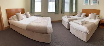 two beds in a hotel room with two bedsvisor at The Rutland Hotel in Douglas