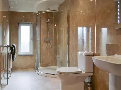 a bathroom with a shower and a toilet and a sink at Crossfeld in Keswick