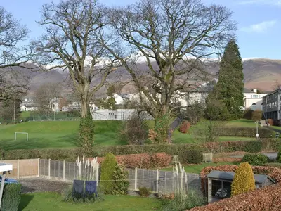 a view of a garden with mountains in the background at Crossfeld in Keswick