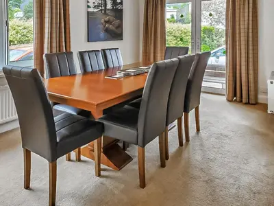 a dining room table with black chairs and a wooden table at Crossfeld in Keswick