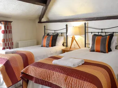 two beds sitting in a room with at Rose Patch Cottage in Keswick