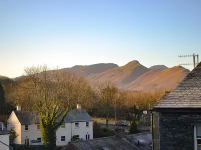 a village with mountains in the background with houses at Blencathra in Keswick