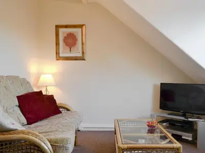a living room with a couch and a tv at Blencathra in Keswick