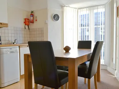 a kitchen with a wooden table and black chairs at Cat Bells in Keswick