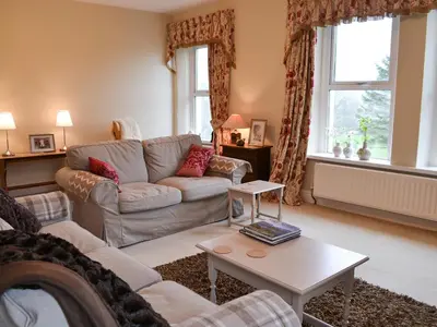 a living room with a couch and a table at Hawthorne House in Bassenthwaite Lake