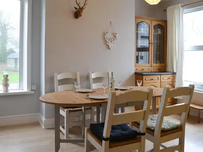 a dining room with a wooden table and chairs at Hawthorne House in Bassenthwaite Lake
