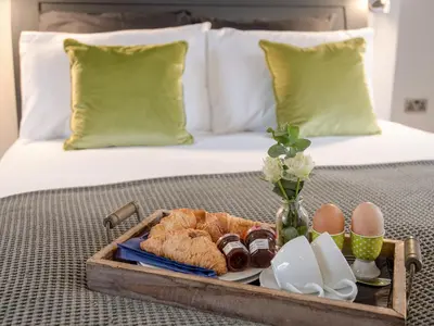 a tray with eggs and croissants on a bed at Granary in Gatehouse of Fleet