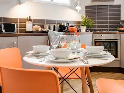 a table with plates and glasses on it in a kitchen at Willow in Gatehouse of Fleet
