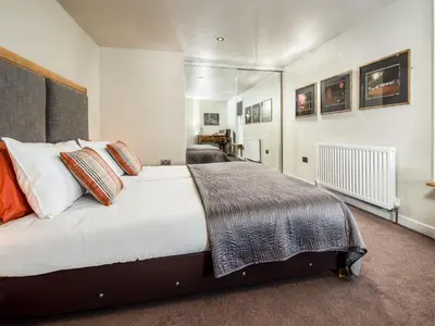 a bedroom with a large white bed with pillows at Willow in Gatehouse of Fleet
