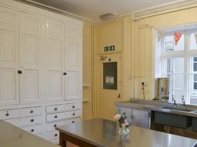 a kitchen with white cabinets and a sink at Blaithwaite House in Blencogo