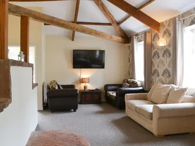 a living room with a couch and a tv at Blaithwaite Stables in Blencogo