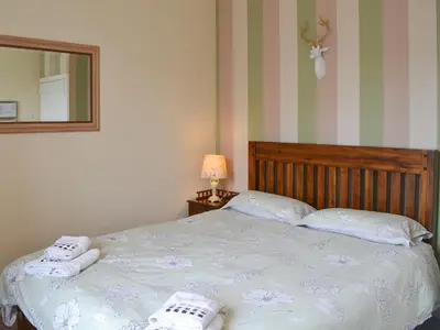 a bedroom with a bed with two towels on it at Blaithwaite Stables in Blencogo