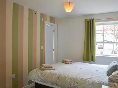 a bedroom with a bed with towels on it at Blaithwaite Stables in Blencogo