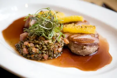 a plate of food with meat and beans and gravy at Western House Hotel At Ayr Racecourse in Ayr
