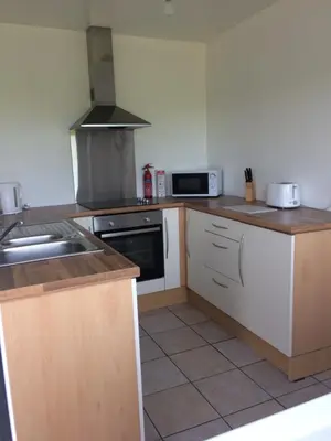 a kitchen with a sink and a stove at Ayrshire cottage in Kilmarnock