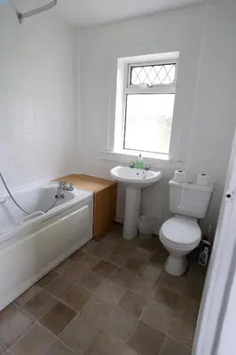 a bathroom with a tub and a toilet and a sink at Ayrshire cottage in Kilmarnock