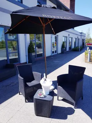a patio with two chairs and an umbrella at Smiths At Gretna Green Hotel in Gretna Green