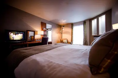 a hotel room with a bed and a television at Smiths At Gretna Green Hotel in Gretna Green