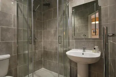 a bathroom with a shower and a sink and a toilet at The Lion and The Lamb in Seascale