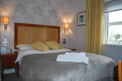 a bedroom with a bed with a towel on it at The Lion and The Lamb in Seascale