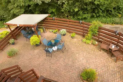 an overhead view of a patio with tables and chairs at The Hill Hotel in Dumfries