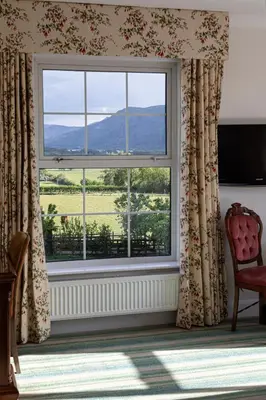 a window with a view of a field at Lake District Castle Inn Hotel & Spa in Keswick