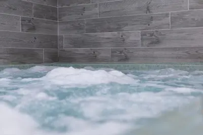 a bath tub filled with snow in front of a wall at Lake District Castle Inn Hotel & Spa in Keswick