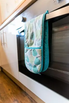 a toaster oven with a towel hanging on it at Wordsworth Apartment Irene court in Cockermouth