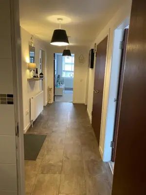 a hallway of a house with a tile floor at Mossie Apartment in Ayr