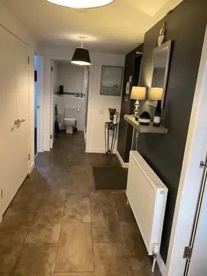 a hallway leading to a bathroom with a toilet at Mossie Apartment in Ayr