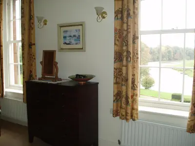 a room with a dresser and a window at Warwick Hall in Carlisle