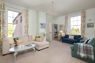 a living room with a couch and a table at Warwick Hall in Carlisle