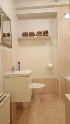 a bathroom with a toilet and a sink and a mirror at Central Dumfries in Dumfries