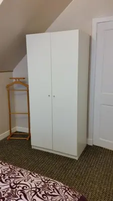 a white cabinet in a room with a bed at Central Dumfries in Dumfries