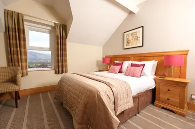 a bedroom with a large bed and a window at The Coledale Inn in Keswick