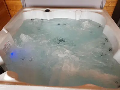 a bath tub filled with blue water in a sink at Green View Lodges in Wigton
